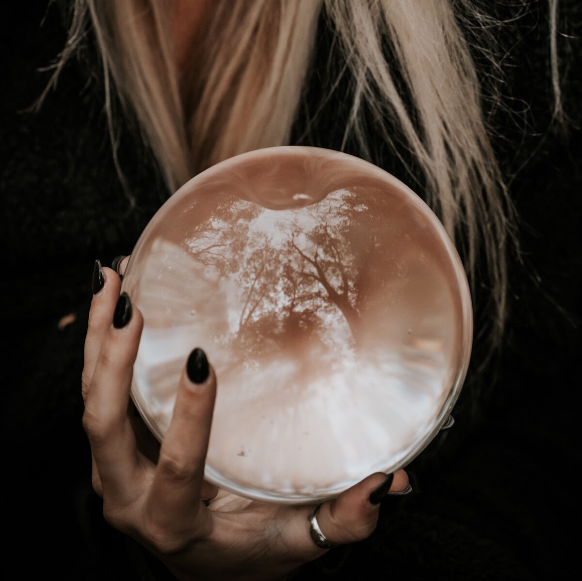 Female hand holding a crystal ball